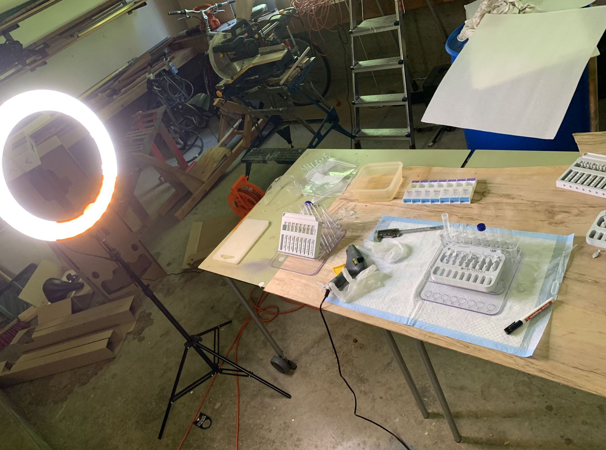 The actual garage — ring light, workbench and 3D-printed trays